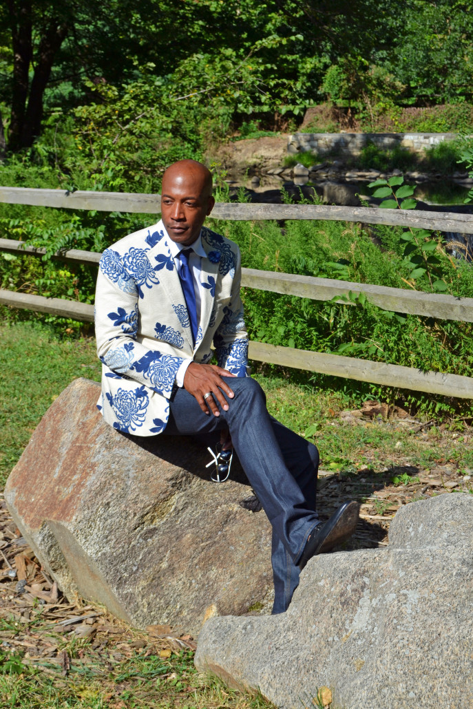 Sitting on the rocks in a floral blazer